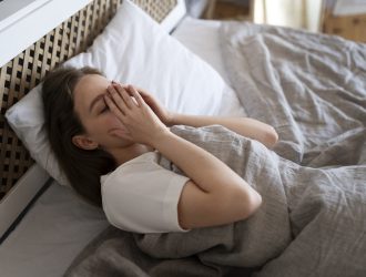 high angle anxious woman laying bed